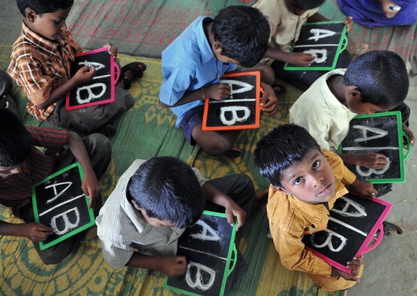 Indian schoolchildren write English alph