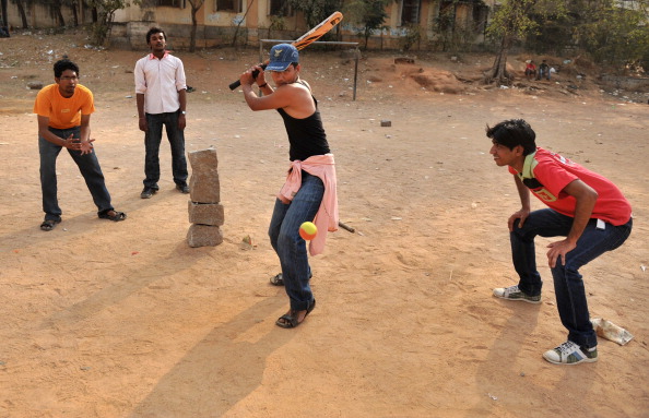 Indian youths play street cricket, local